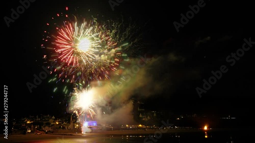 Timelapse with slow motion effect by superpositions of the pictures fading. Colorful show at night over a coastal village. 4K animated footage.