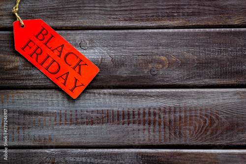 Black friday labels in discount on wooden background top view mock up