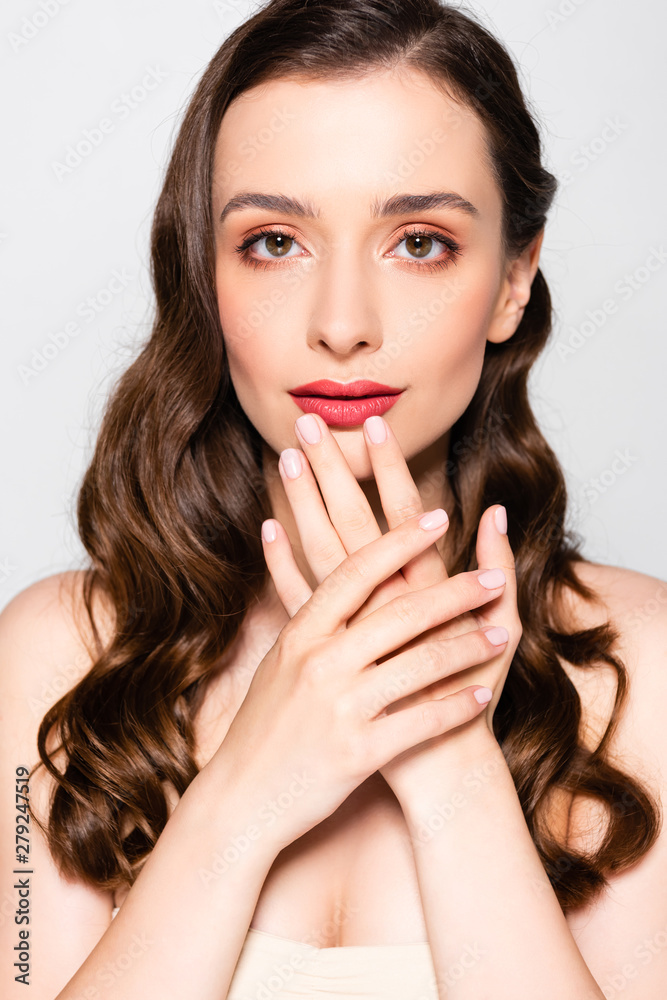 beautiful brunette woman with curls and makeup touching lips isolated on grey beautiful brunette woman with curls and makeup touching lips isolated on grey
