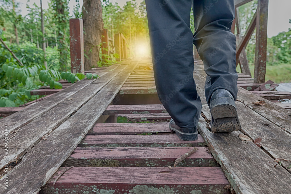Pathway to success concept a man walk on broken wood bridge with space area for write some text on background meaning walk to success concept sometime the way don't not convenient Pathway to success concept a man walk on broken wood bridge with space area for write some text on background meaning walk to success concept sometime the way don't not convenient