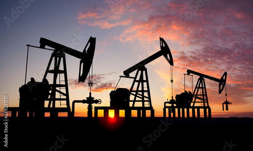 Three oil pumps at sunset