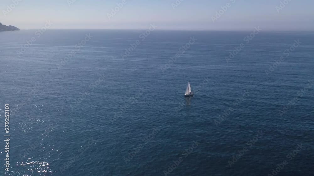 white sailing yacht in the blue sea top view from drone white sailing yacht in the blue sea top view from drone