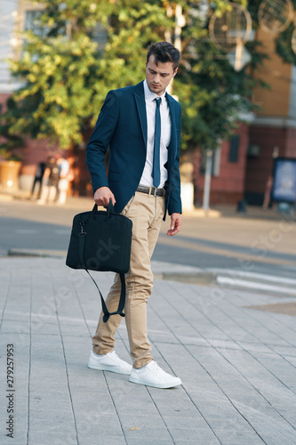 young businessman walking in the street