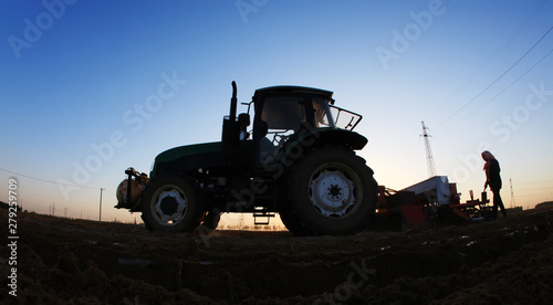Fototapeta Naklejka Na Ścianę i Meble -  The tractor in farmland farming