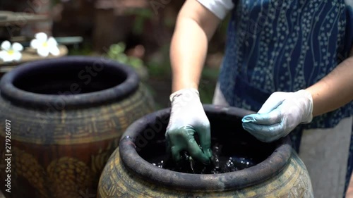 Making northern Thai blue dye fabric cloth textiles with boiling indigo leaf plant