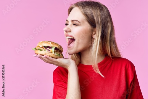 young woman eating hamburger