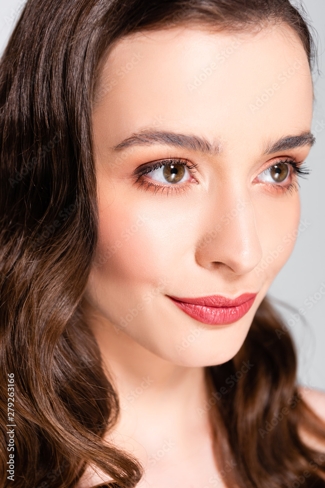 portrait of beautiful brunette young woman with curls and makeup isolated on grey portrait of beautiful brunette young woman with curls and makeup isolated on grey