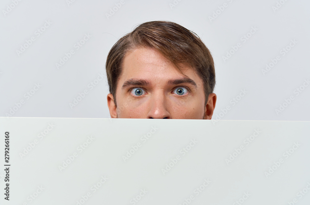 portrait of young man holding blank billboard portrait of young man holding blank billboard