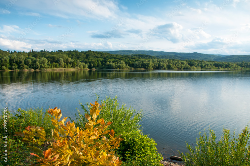 beautiful summer lake against the background of high mountains and blue sky beautiful summer lake against the background of high mountains and blue sky