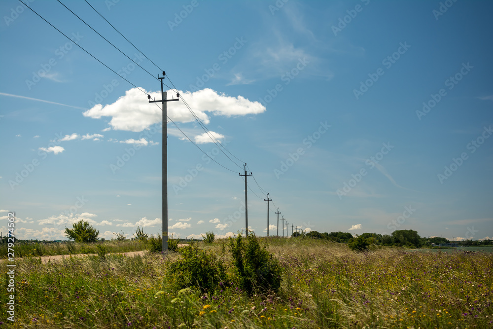 power poles on the road sky