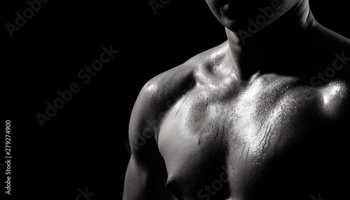 Asian Big Muscle Fitness Man exercise show arms, bicep, chest with sweat from heat. Young Sport Male six packs shoot in low key lighting exposure with shadow contrast, copy space