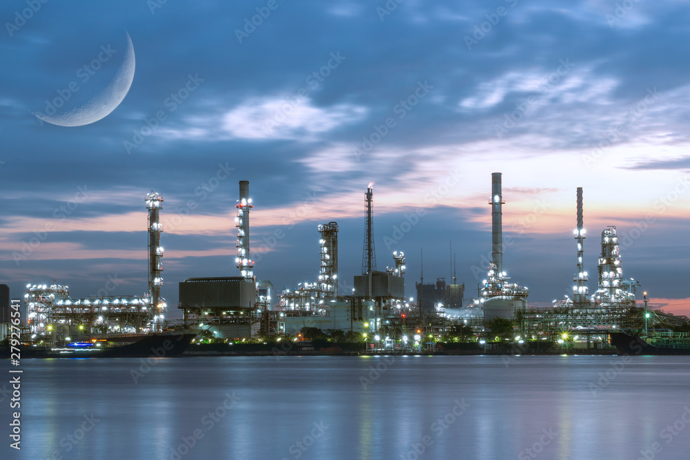 Double Exposure, C-shaped section or Crescent of the moon surface with Oil refinery industry plant near the river before sunrise.