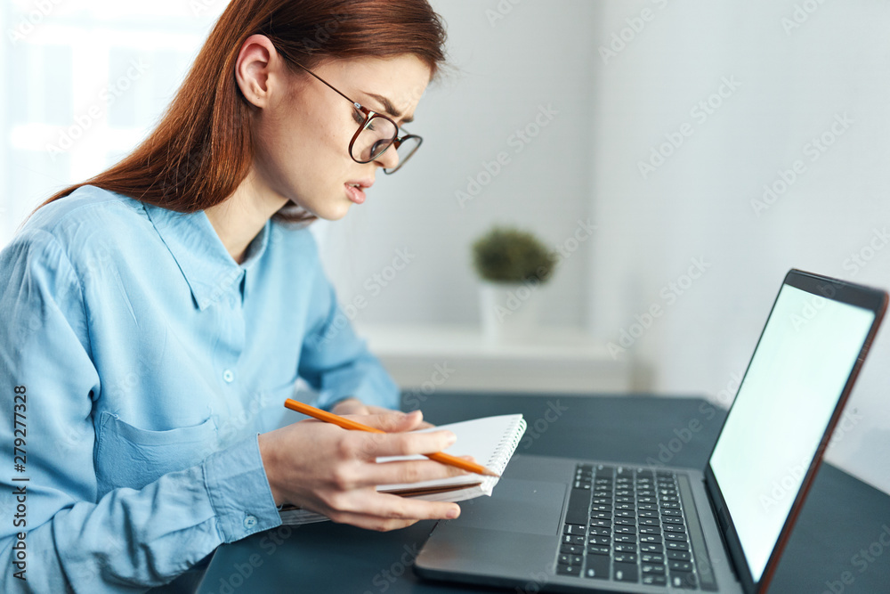 young woman working on her laptop in office young woman working on her laptop in office