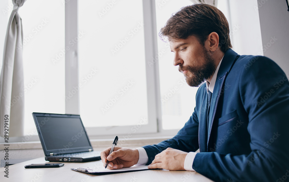 businessman working on laptop in an office businessman working on laptop in an office