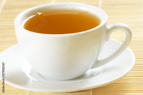 Fresh hot tea in white cup cllose-up