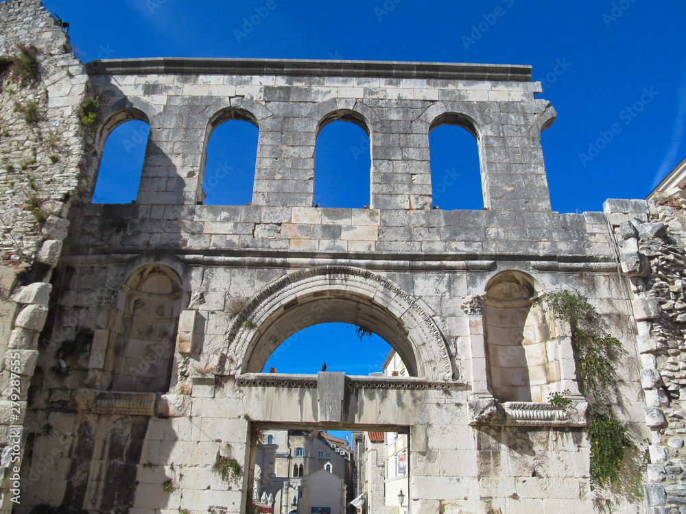 The Silver Gate of Diocletian's Palace in the city Split, Croatia. Old ancient buildings on blue sky background on a sunny day. 