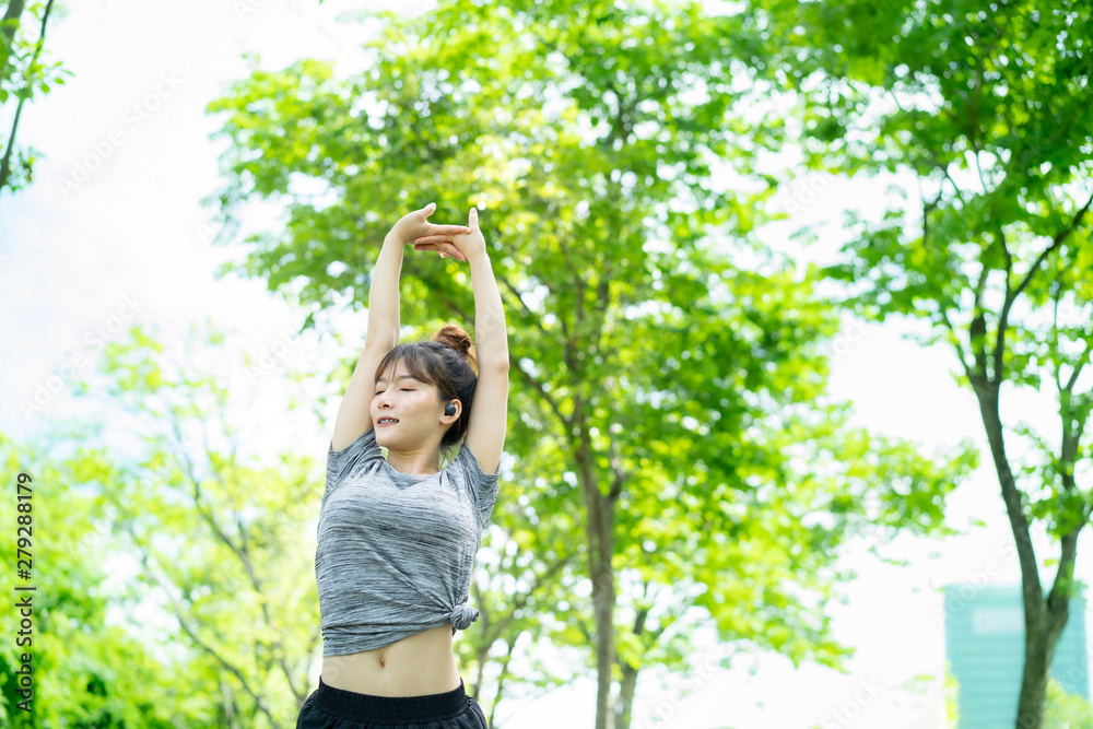 People are exercising at the park with blurry background People are exercising at the park with blurry background