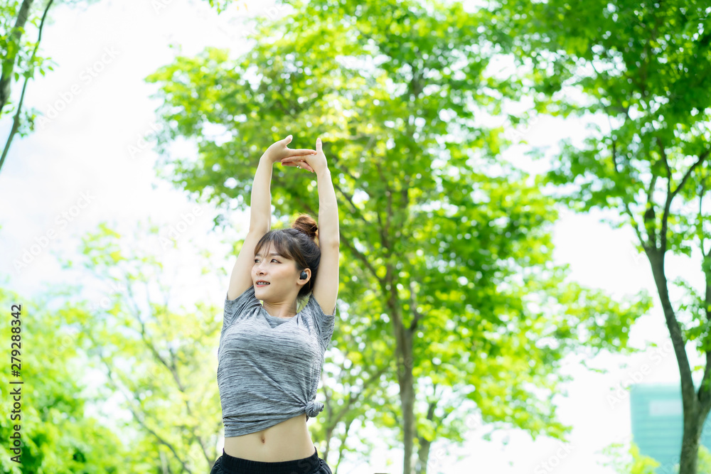 People are exercising at the park with blurry background People are exercising at the park with blurry background