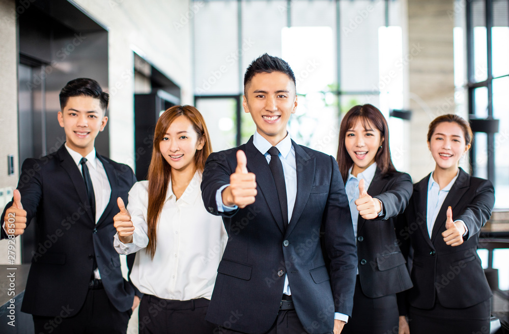 asian business team standing and showing thumbs up asian business team standing and showing thumbs up