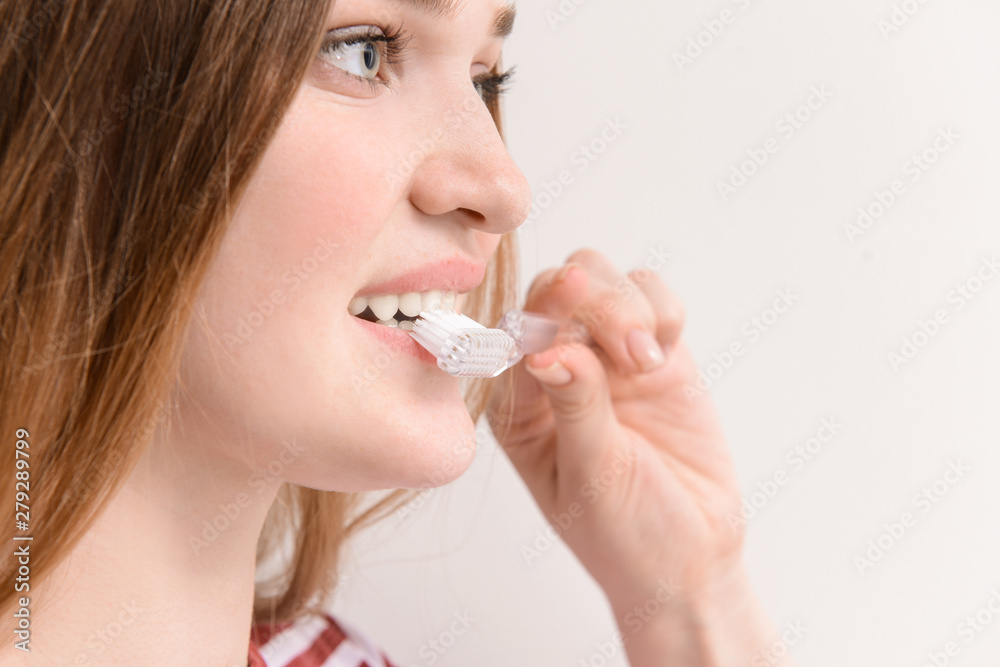 Woman with toothbrush on light background, closeup. Concept of dental hygiene Woman with toothbrush on light background, closeup. Concept of dental hygiene