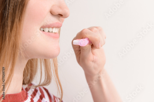 Woman with toothbrush on light background  closeup. Concept of dental hygiene