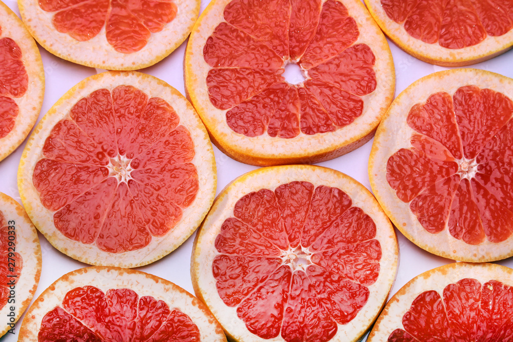 Background formed with sliced grapefruits Background formed with sliced grapefruits