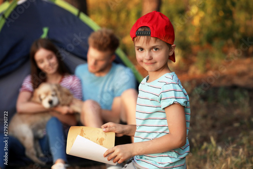 Little boy with map in camp