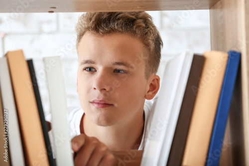 Male student choosing books...