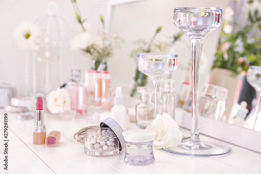 Makeup cosmetics on white dressing table
