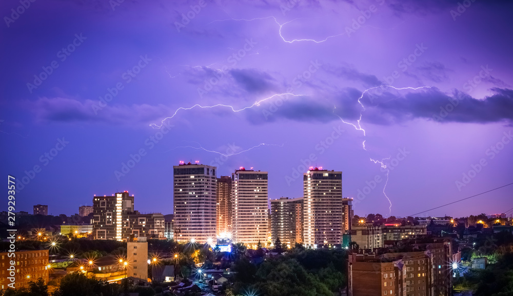 Beautiful lightning in the sky at the city at night. Lightning strikes in the dark sky