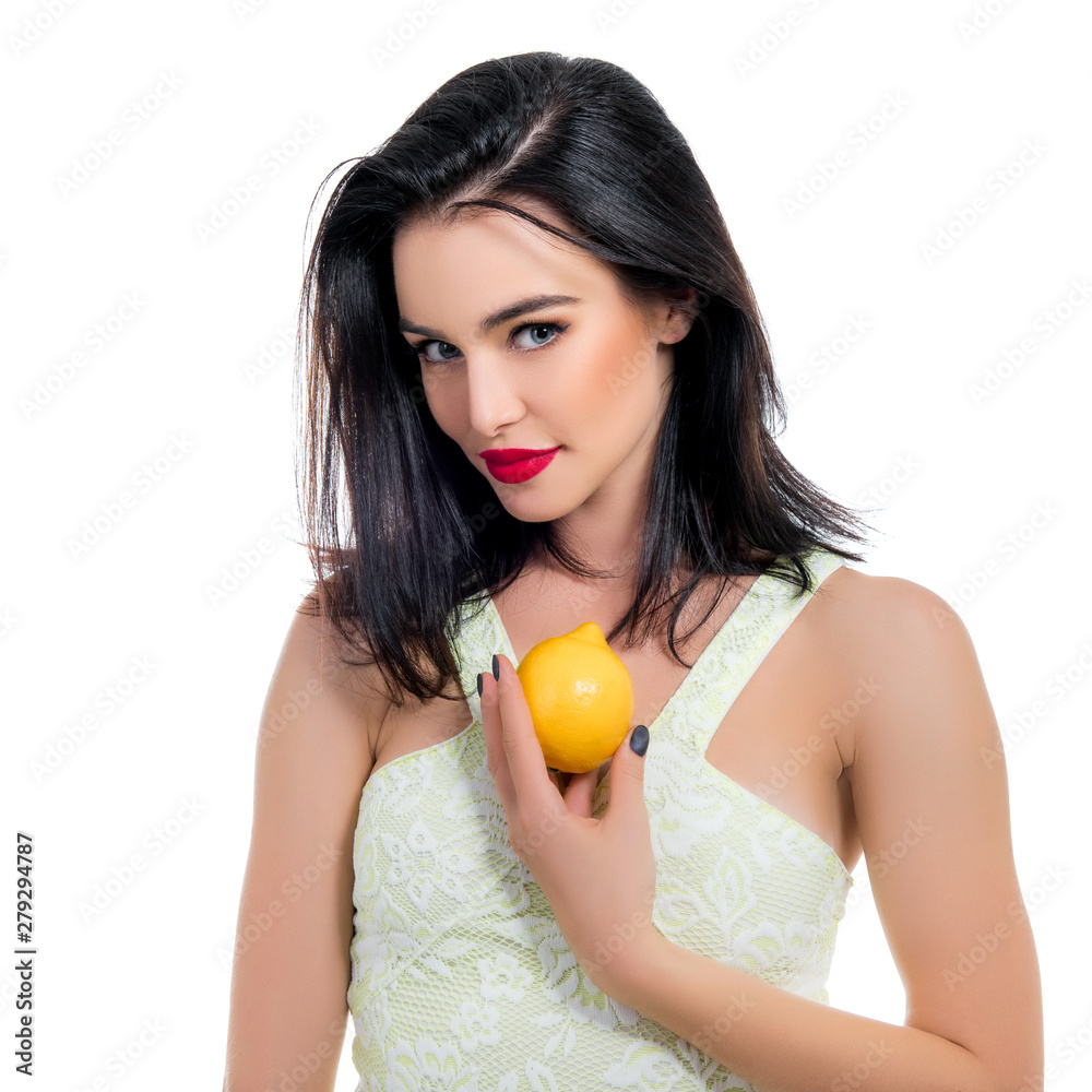 Excited beautiful girl holding lemon and posing in studio over white background. Excited beautiful girl holding lemon and posing in studio over white background.