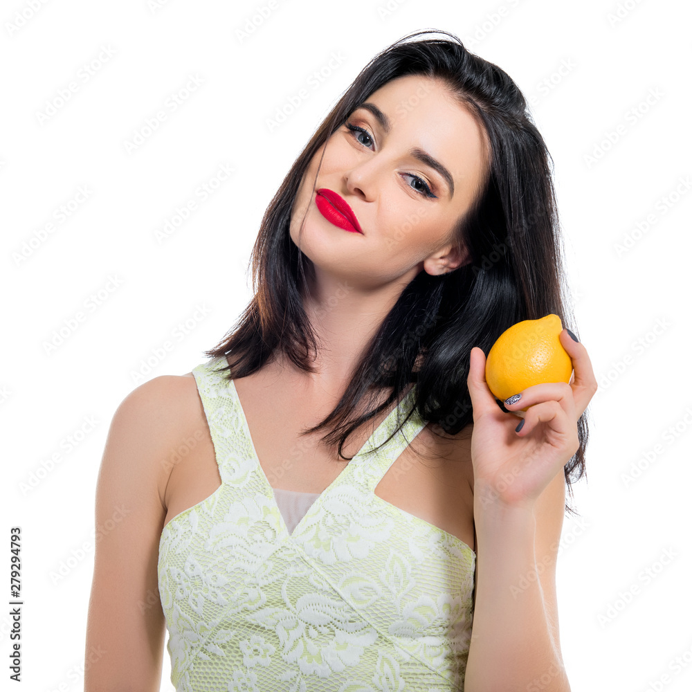 Excited beautiful girl holding lemon and posing in studio over white background. Excited beautiful girl holding lemon and posing in studio over white background.