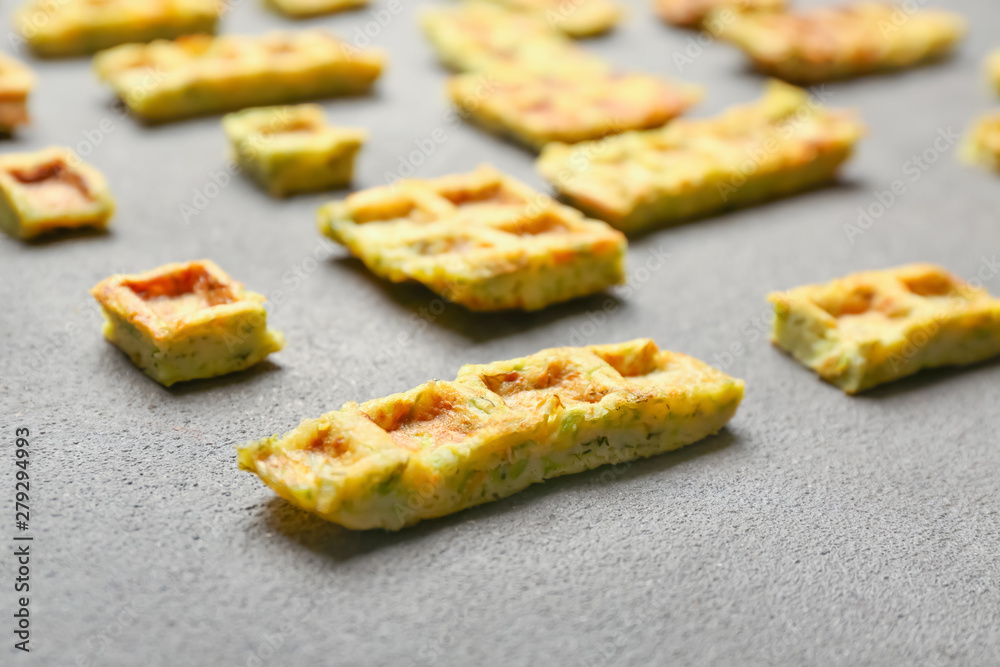Pieces of squash waffles on grey background