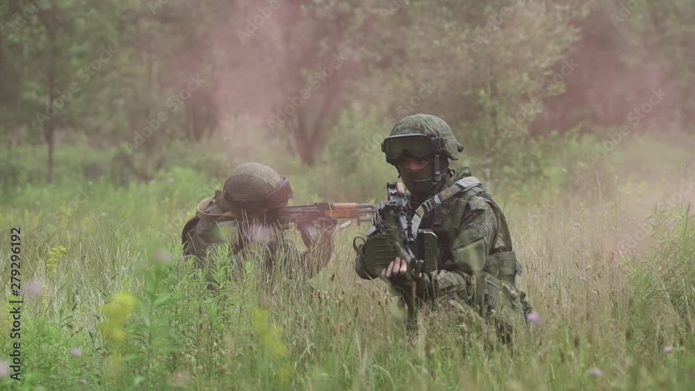 Soldiers in camouflage with assault rifles, out of the ambush in the field, military action in the steppe area. Soldiers in camouflage with assault rifles, out of the ambush in the field, military action in the steppe area.