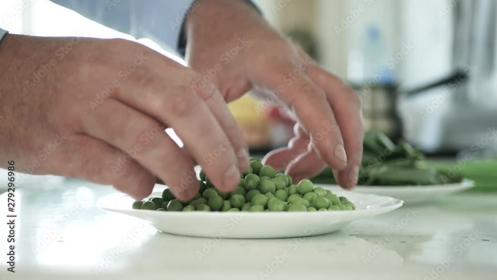Man in the Kitchen Select and Fresh Green Peas for Cooking Man in the Kitchen Select and Fresh Green Peas for Cooking