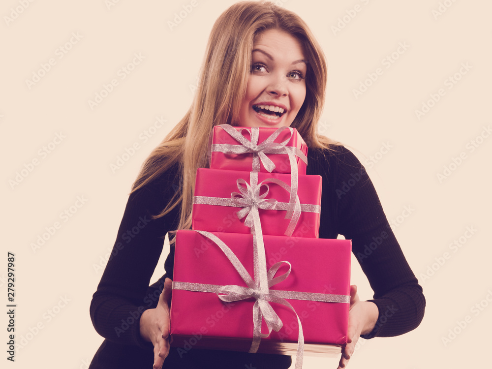 Girl holding stack of pink gift boxes Girl holding stack of pink gift boxes
