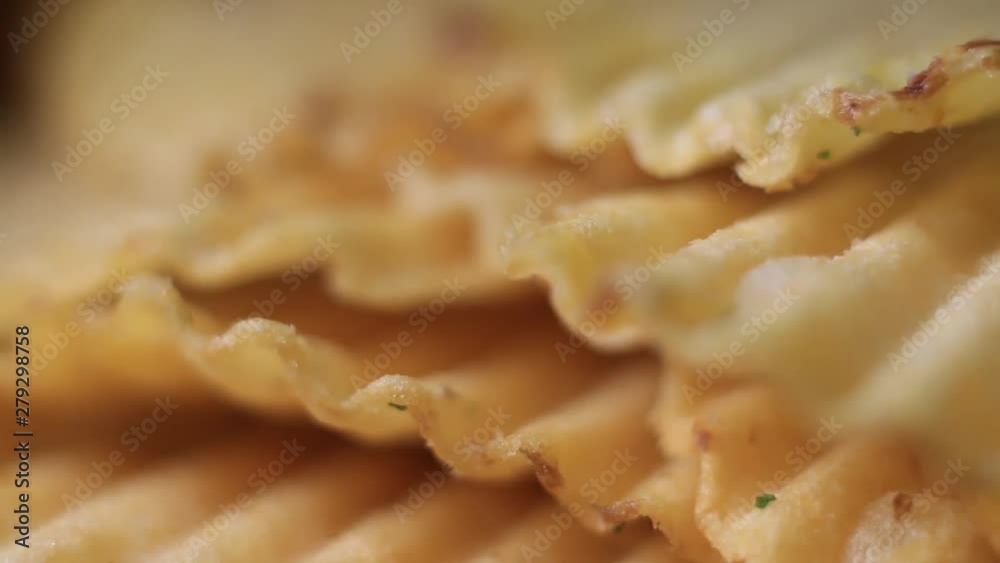 Extreme Close Up Of Rotating Rippled Potato Chips. Extreme Close Up Of Rotating Rippled Potato Chips.