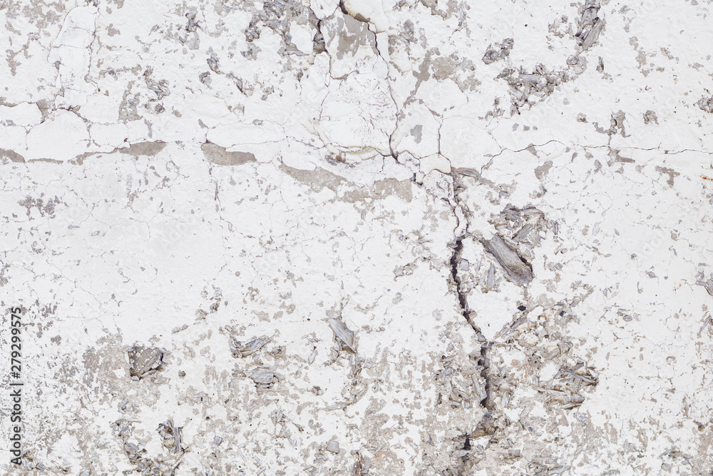 Obraz premium Cracked concrete texture background. Grey surface with cracks close up. Cracked grey old wall as background.
