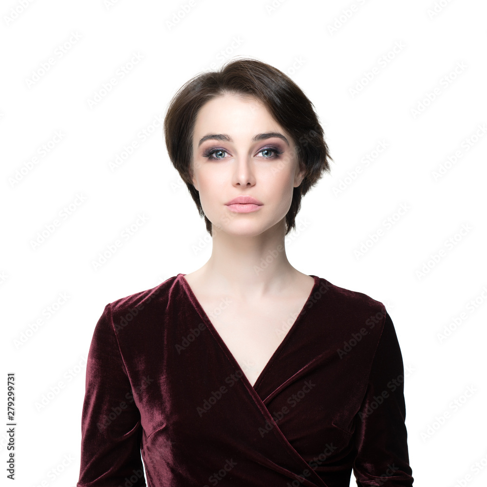 Beauty female portrait. Young attractive woman posing at studio over white background. Beautiful model with perfect make-up dressed evening burgundy dress looking at camera. Beauty female portrait. Young attractive woman posing at studio over white background. Beautiful model with perfect make-up dressed evening burgundy dress looking at camera.