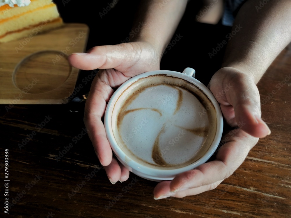 Cappuccino coffee in a warm glass with soft milk bubbles Soft on the hand Cappuccino coffee in a warm glass with soft milk bubbles Soft on the hand