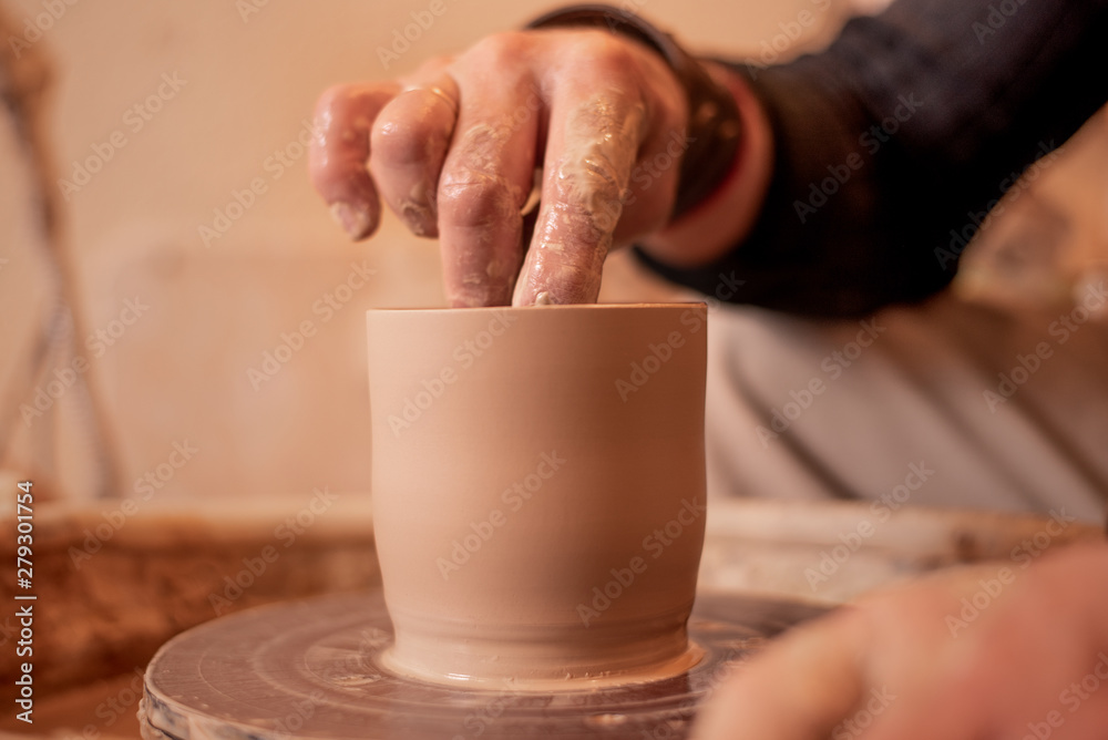 potter's hands work with clay, making it a product potter's hands work with clay, making it a product