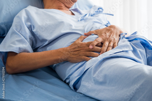 Wallpaper Mural Senior male patient having stomach ache on bed Torontodigital.ca