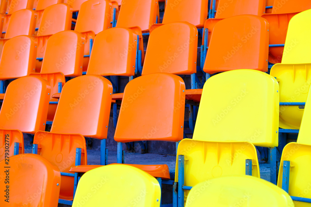 Naklejka premium bright empty plastic seats on the sports platform of the stadium