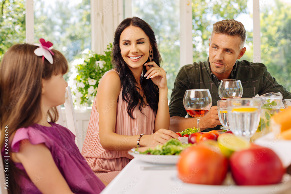 Woman feeling happy having lunch with husband and daughter