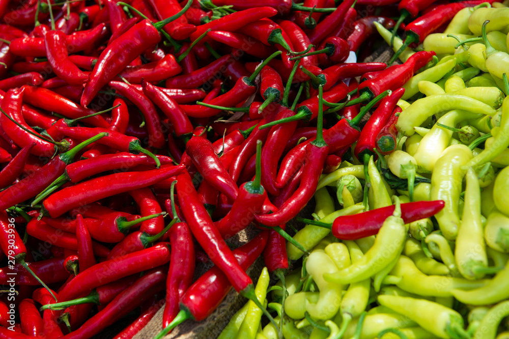 Red hot fresh raw chili peppers and sweet paprika sold on outdoor market