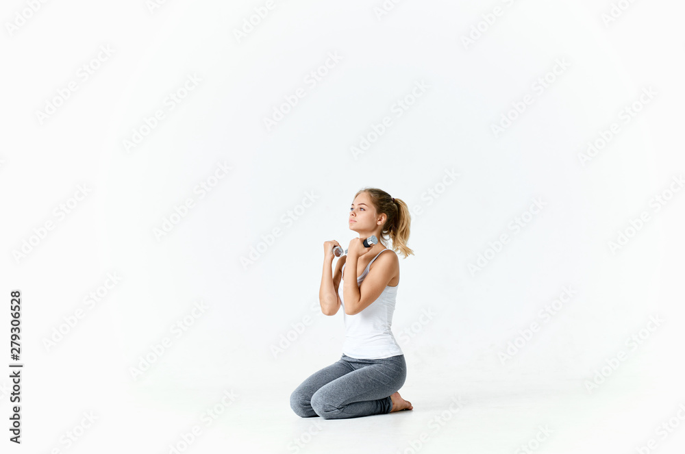 young woman sitting on the floor doing fitness