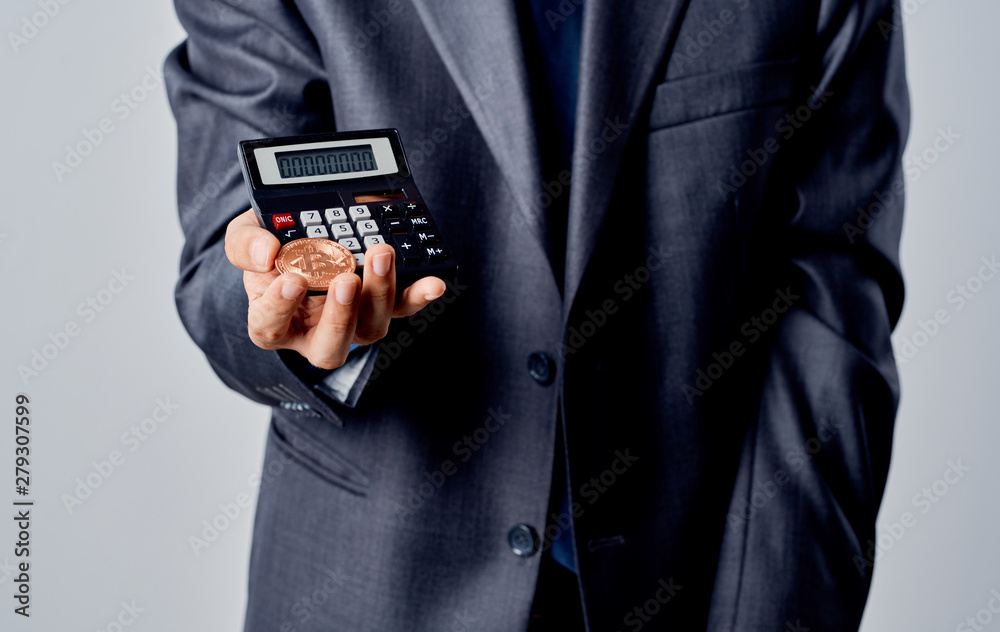 man holds calculator