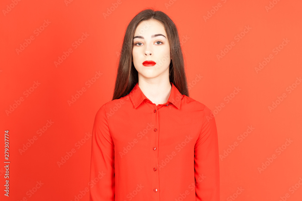 Fototapeta premium portrait of young woman on red background