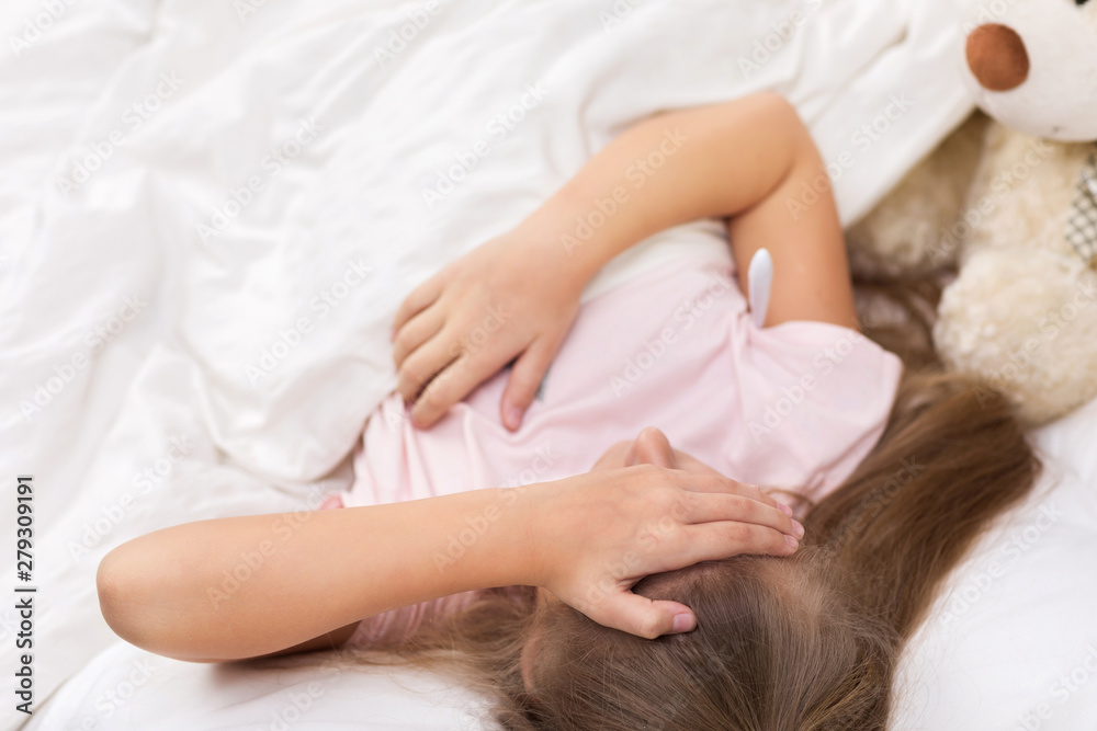 Sick little child girl lying in bed with thermometer. Cold flu season Sick little child girl lying in bed with thermometer. Cold flu season