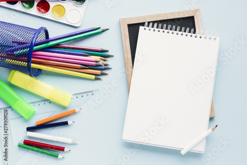 Blank notepad next to crayons